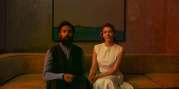 Himesh Patel and Elizabeth Olsen in THE ASSESSMENT, a Magnolia Pictures release. Photo credit: Magnus Jønck. © 2024 Number 9 Films Assessment Limited, TA Co-Production GmbH, ShivHans Productions, LLC, TA2022 Investors, LLC, Tiki Tāne Pictures, LLC. Photo courtesy of Magnolia Pictures.